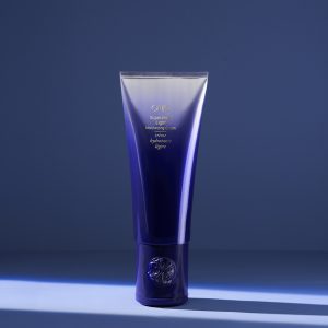 Luxury hair care cream tube on display.