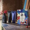 Luxury haircare products displayed on wooden table.