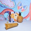 Colorful skincare products with abstract butterfly background