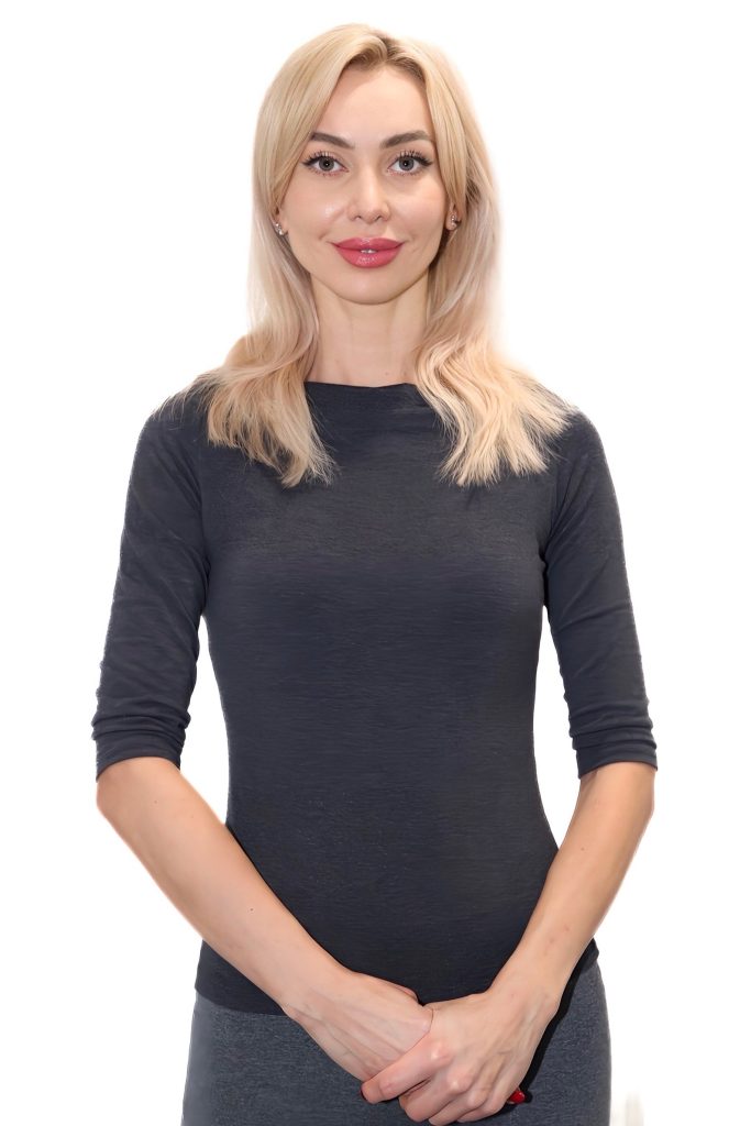 Person in black top smiling confidently at camera